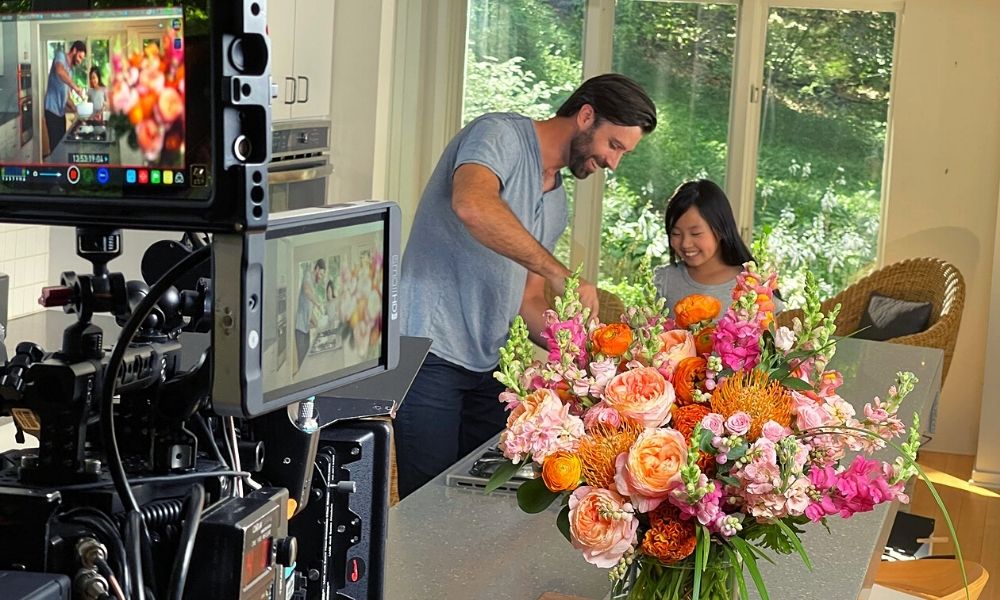 That Flower Feeling- At Home- features a father and daughter cooking in the kitchen- accompanied by beautiful flowers!