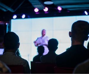 Image description: Man speaking at a tech convention