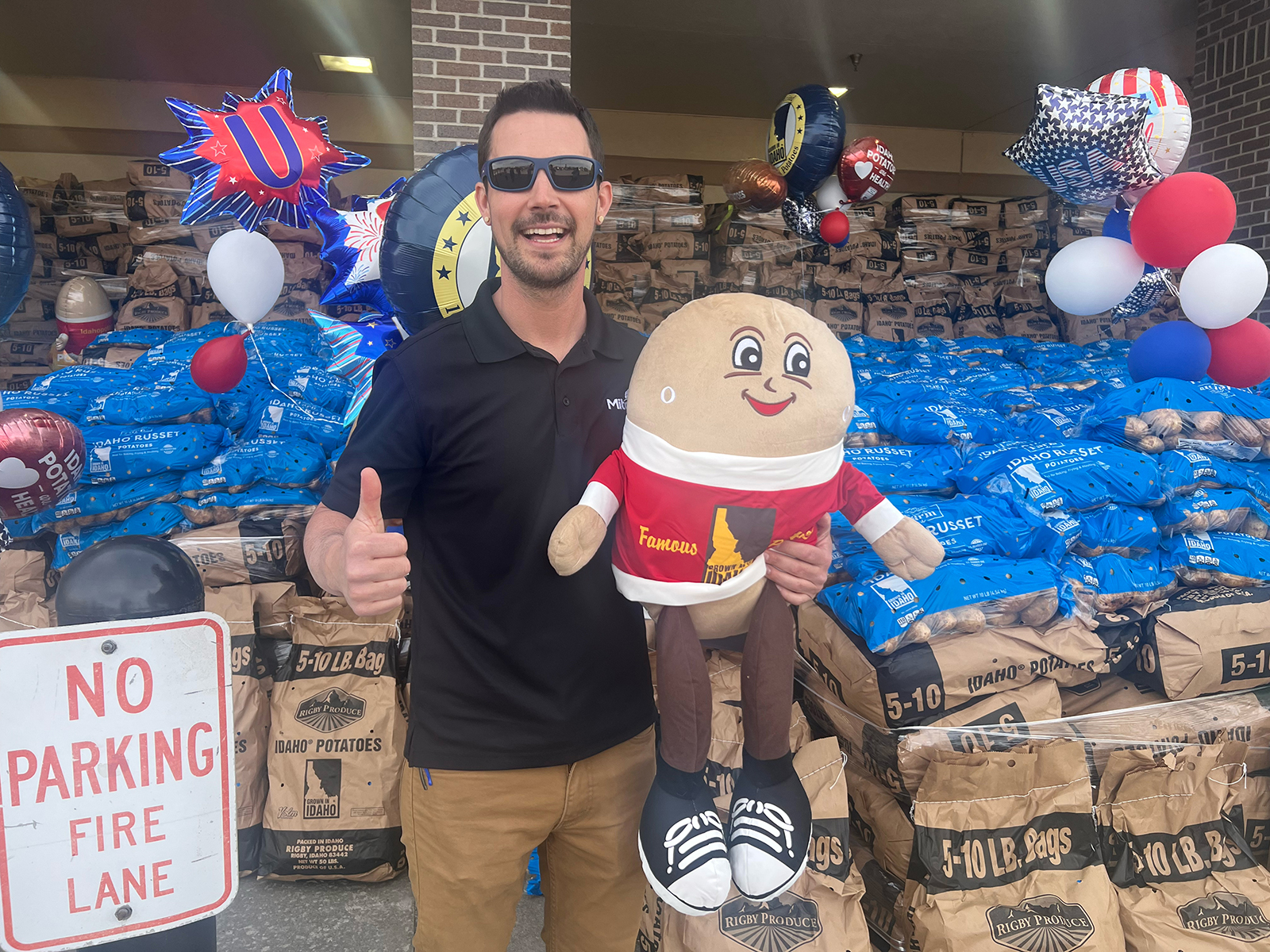 Mitchell Mayor Jordan Hanson gives a big ‘thumbs up’ with Spuddy Buddy in front of the World’s Largest Idaho Potato Display at County Fair.