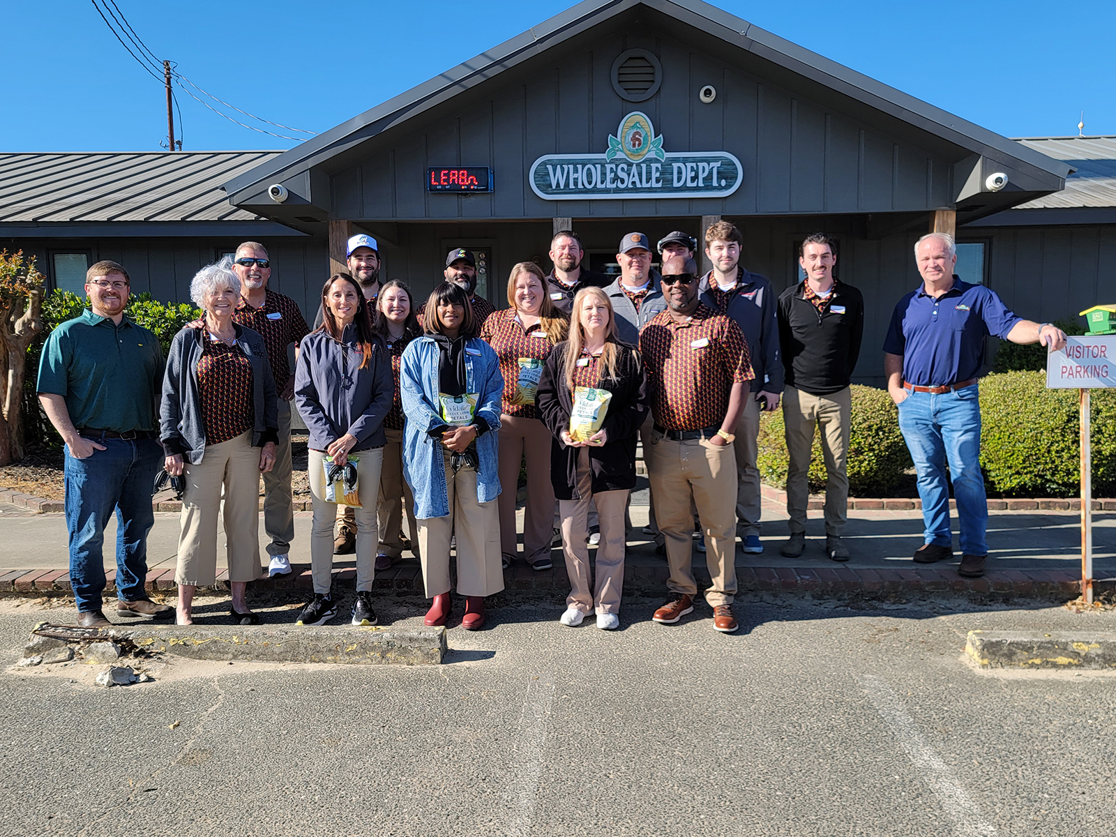 The class completed an informative tour of Bland Farms onion packing facility by Luke McBee (left) and Sloan Lott (right), and were sent home with some of their tasty onion petals.