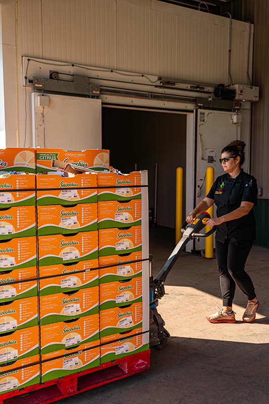 Executive Chef and Program Manager, Shauna Alvarez, assisting with unloading the Little Smoochies mandarins donated by Consalo Family Farms